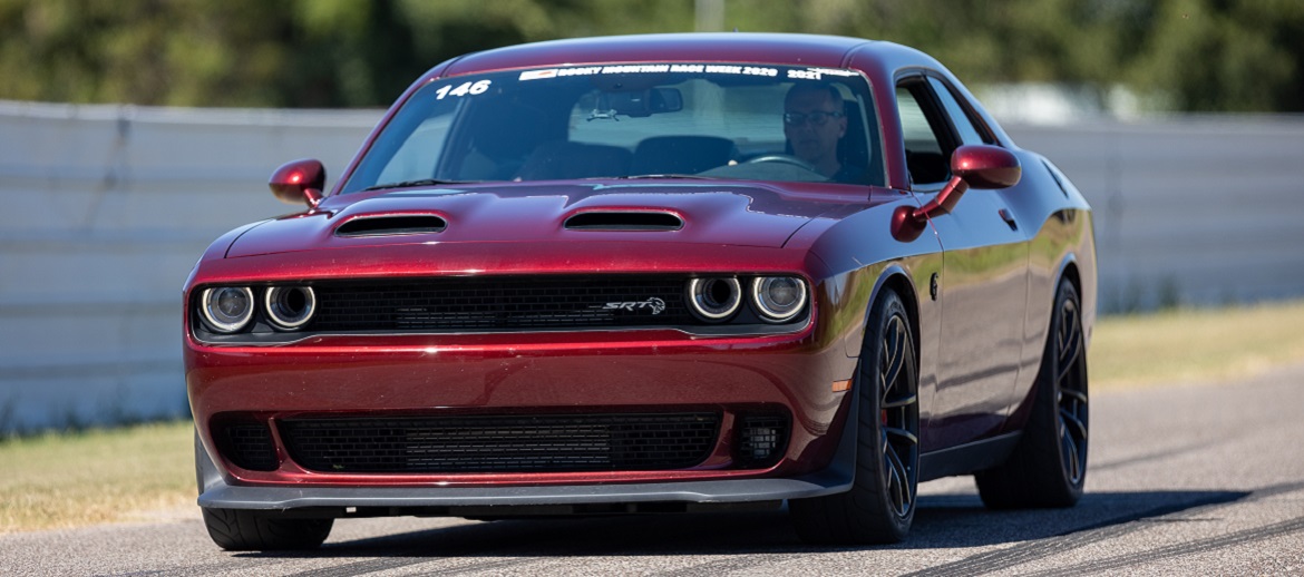 Frank Wanicka driving his octane red Challenger on a track