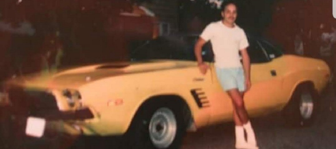 Paul Castiglione's brother standing in front of his '72 Challenger in 1989.