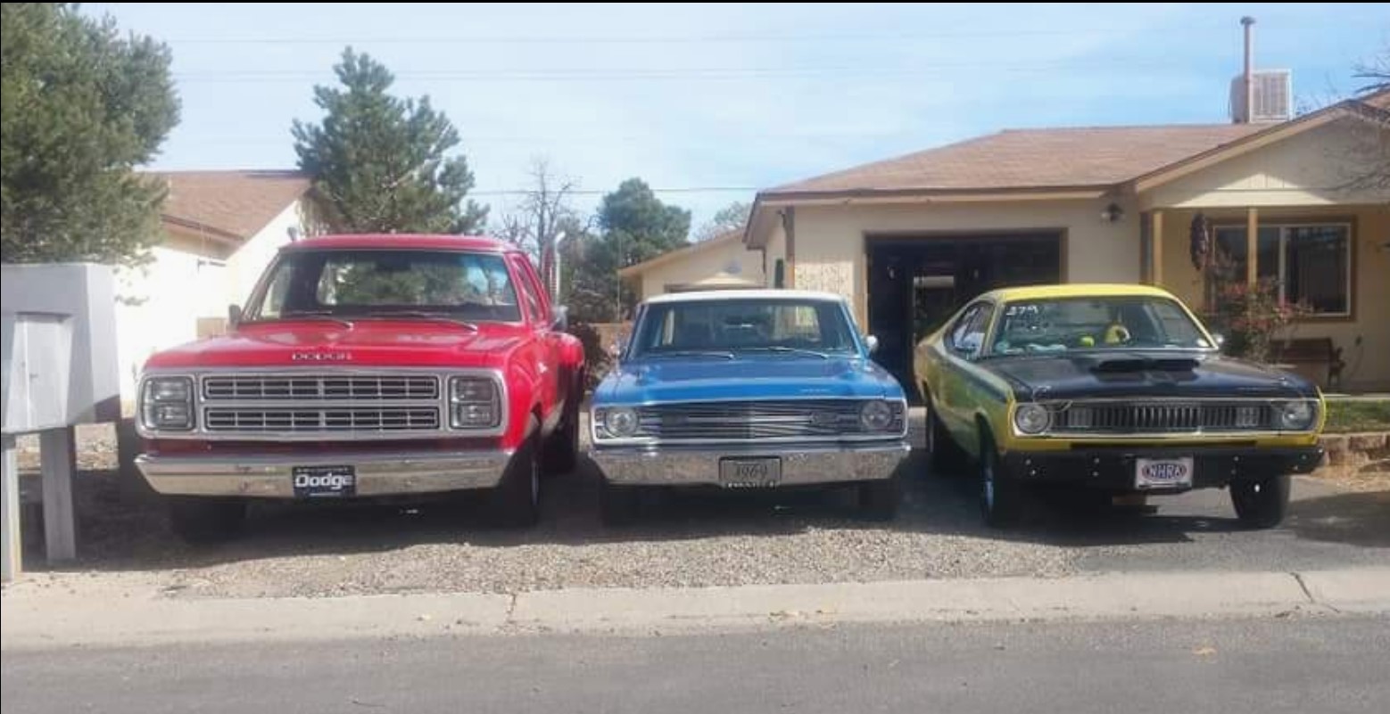 truck and 2 cars sitting in a driveway