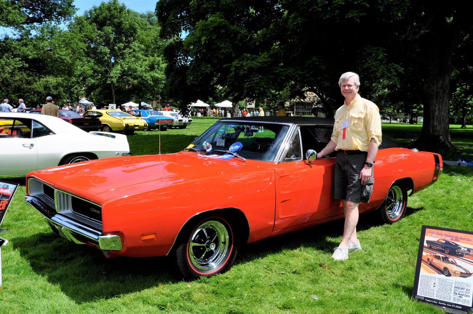 man standing next to vintage car