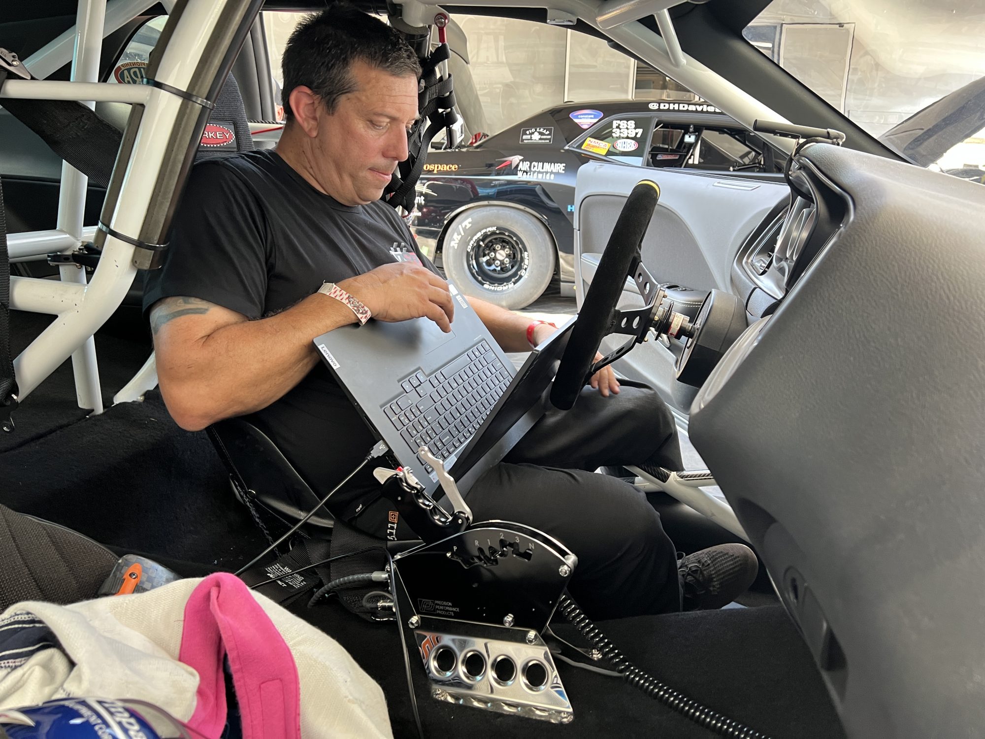 man tuning his drag racing car