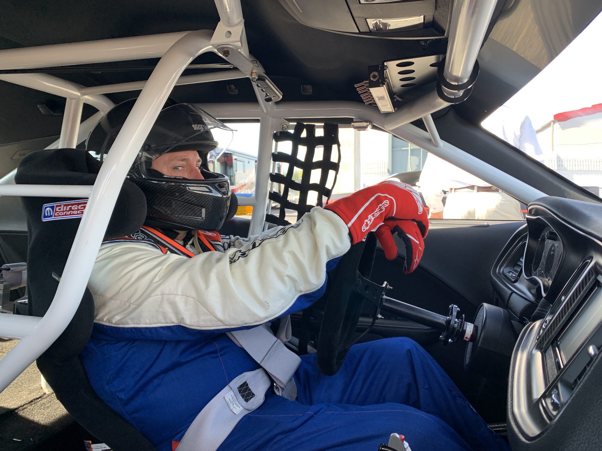 man sitting in race car getting ready to race