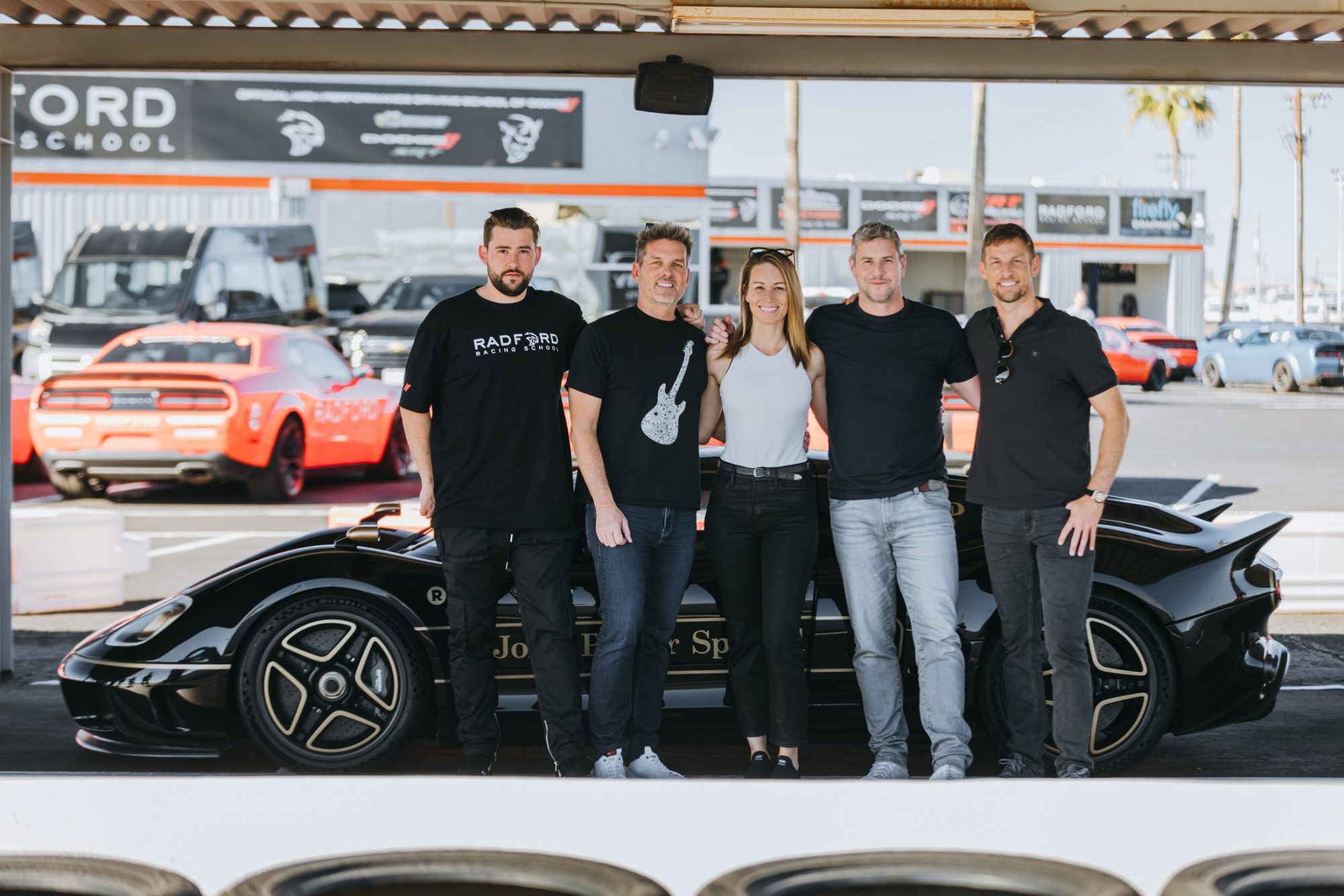 Group of people standing in front of a car at Radford Racing School