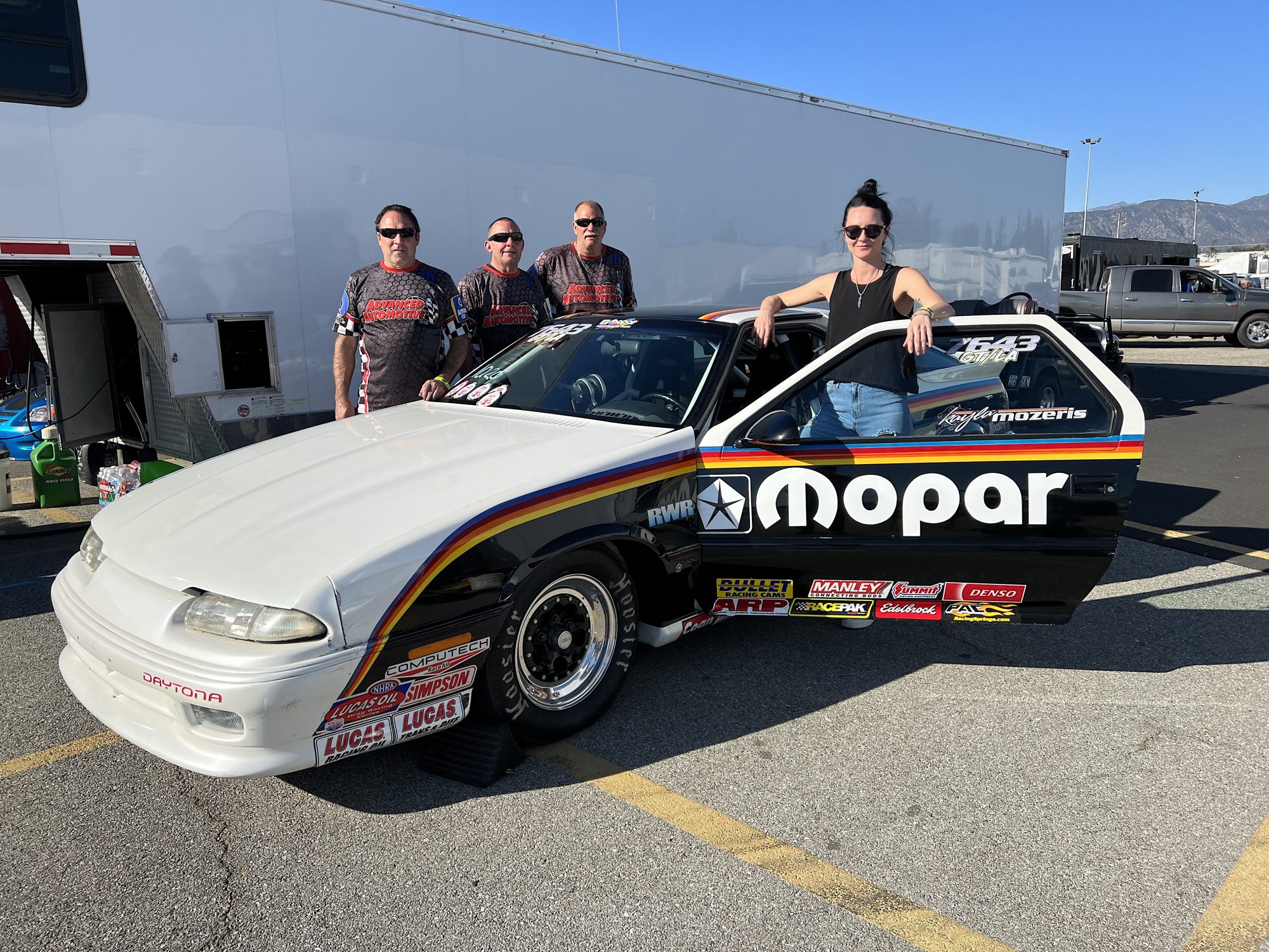 Woman standing with her drag racing car