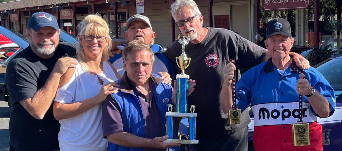 Group of club members showing off their trophies