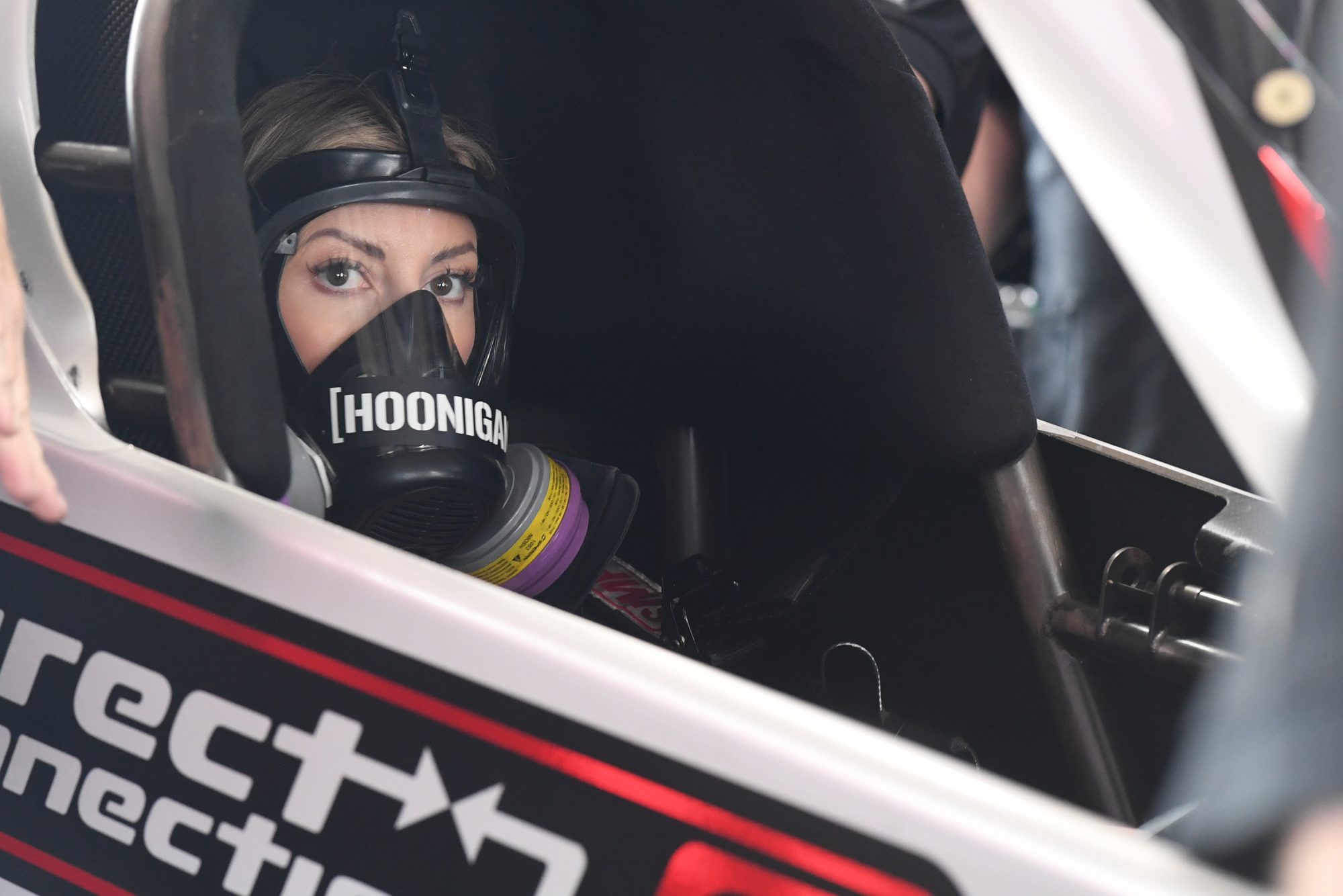 Leah Pruett sitting in her drag car