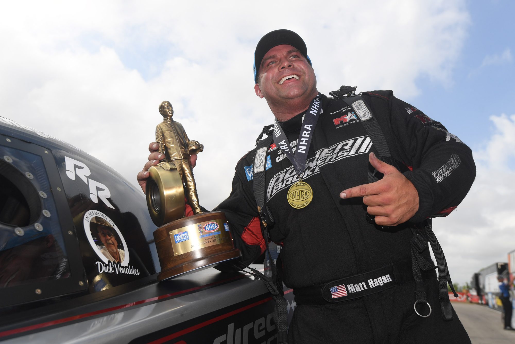 Matt Hagan holding a Wally trophy