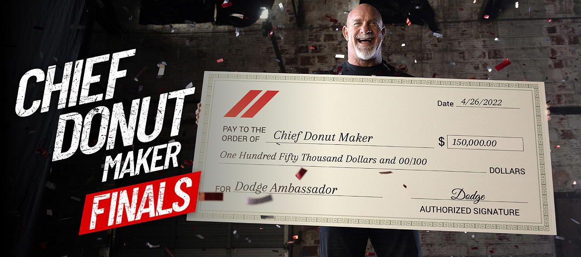 Bill Gooldberg holding up a check for the Chief Donut Maker