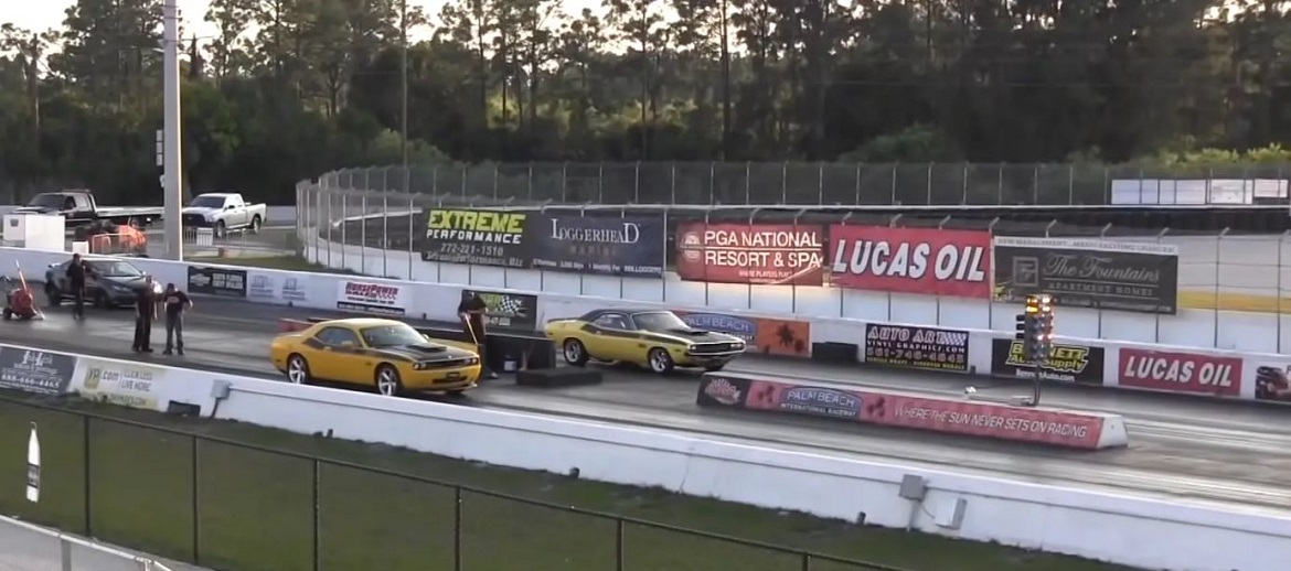 modern and vintage challenger side by side on the track