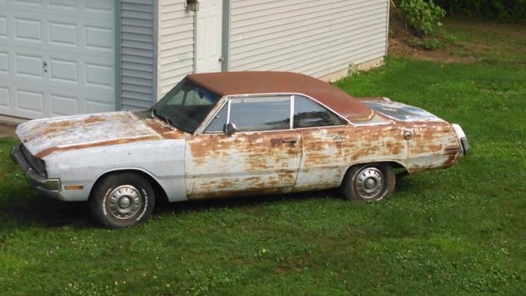 old car sitting on a lawn