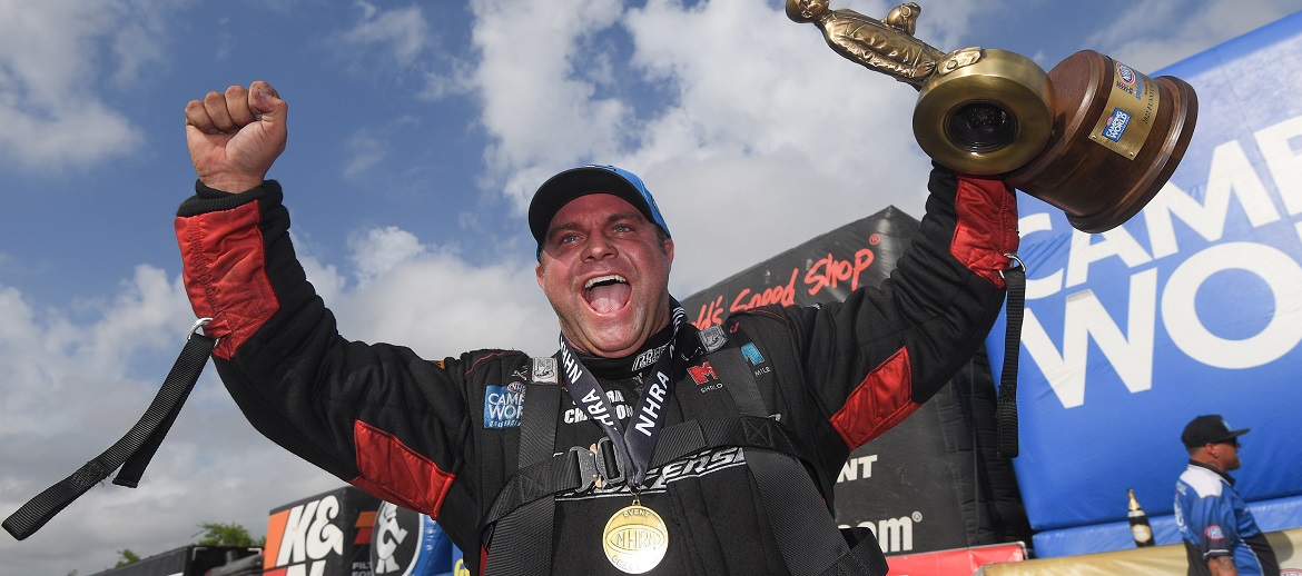 Matt Hagan holding a trophy celebrating a win