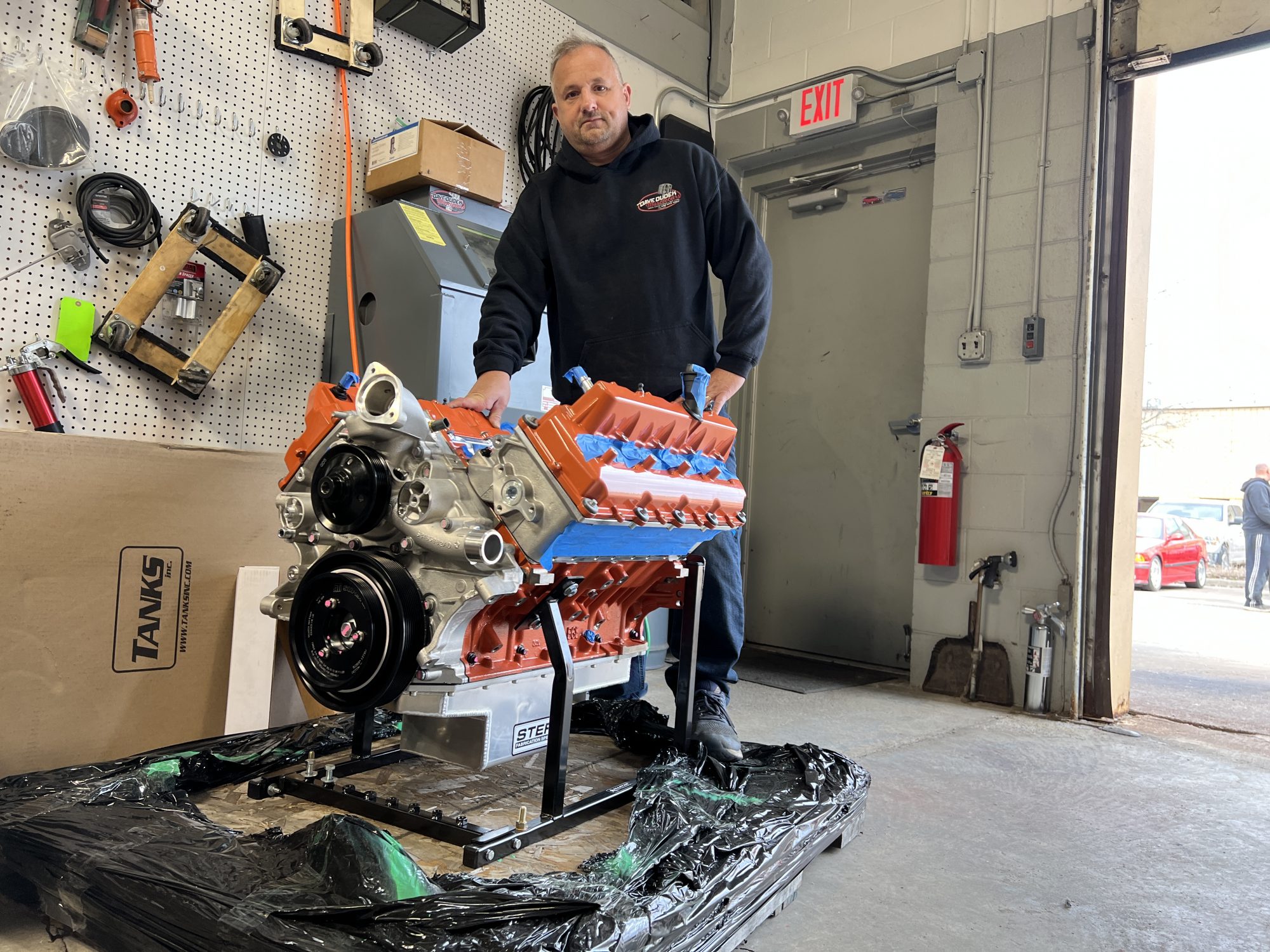 Man standing next to an engine