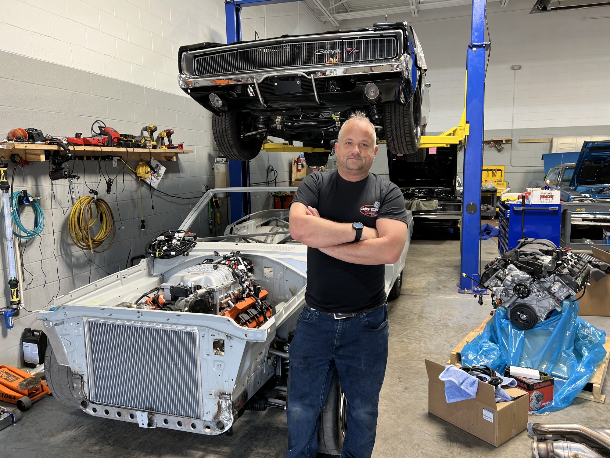 Man standing next to his cars