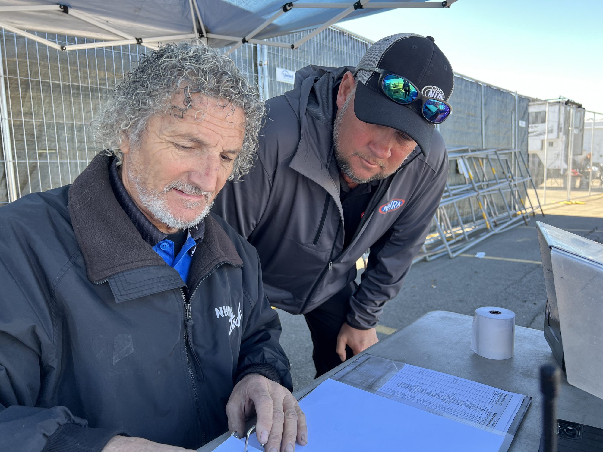 Two men looking at paperwork