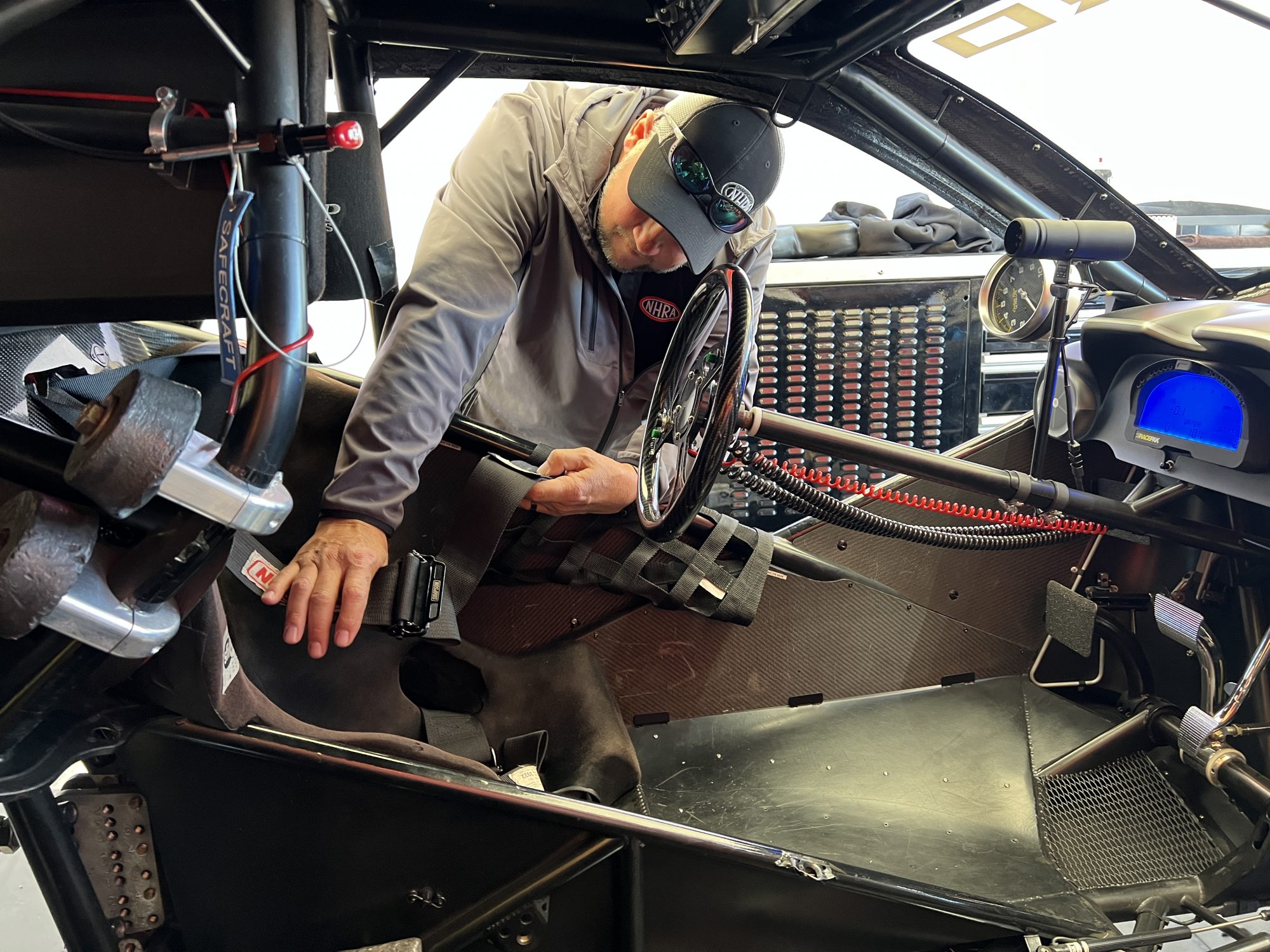 Man checking out race car