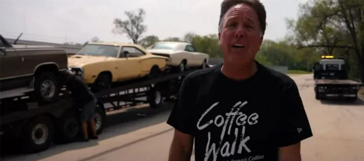 Dennis Collins in front of a transporter carrying classic Dodge vehicles