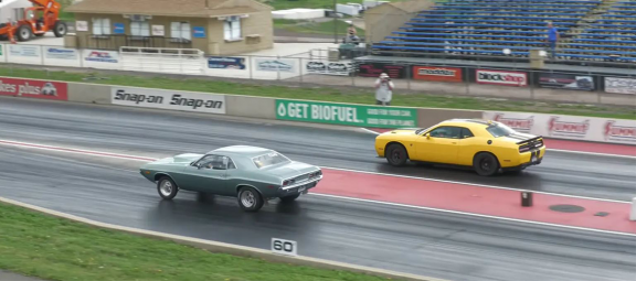 Two muscle cars racing on a drag strip