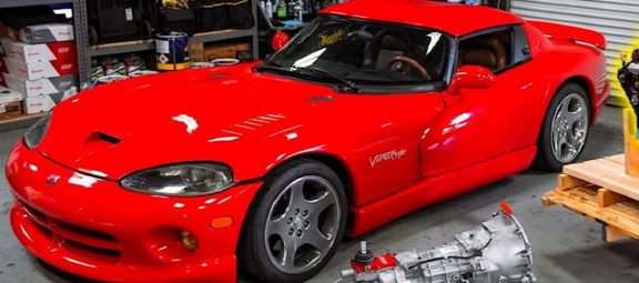a red 2001 Dodge Viper in a garage