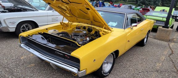 a yellow convertible Charger R/T with the hood popped