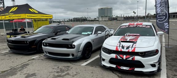 lineup of two Dodge Challengers and a Dodge Charger
